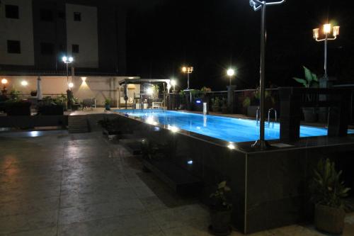 a swimming pool at night with lights at Residence MASSOU in Yaoundé