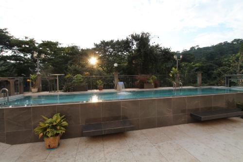 a large swimming pool with a tile wall at Residence MASSOU in Yaoundé