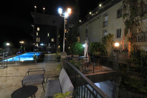 a view of a swimming pool at night at Residence MASSOU in Yaoundé