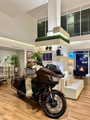 a teddy bear sitting on a motorcycle in a living room at C Y C Heritage Hotel in George Town