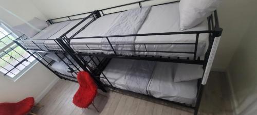a bunk bed in a room with a red sock at Large, Central, Lovely & Cozy 4bed/2bath - House by Everbank Stadium JACKSONVILLE in Jacksonville