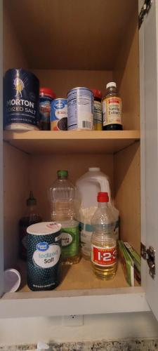 a cupboard filled with lots of food and drinks at Large, Central, Lovely & Cozy 4bed/2bath - House by Everbank Stadium JACKSONVILLE in Jacksonville