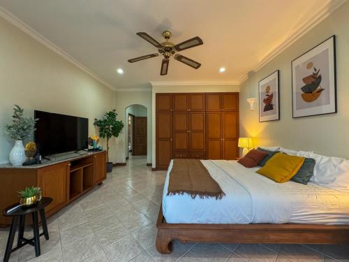 a bedroom with a large bed and a ceiling fan at View Talay Longstay in Jomtien Beach