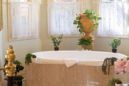 a bath tub with a vase on top of it at Rapunzels Cottage 1BR Fairytale Studio Stay in Ballarat
