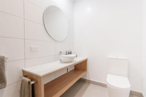 a bathroom with a sink and a mirror at Waratah On York in Launceston