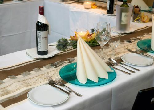 a table with a bottle of wine and a plate on it at Ibis Wien Mariahilf in Vienna