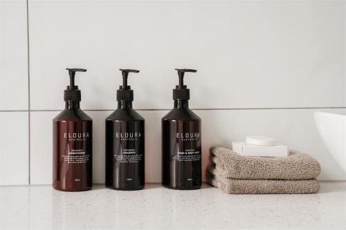 a group of three wine bottles sitting on a counter at Waratah On York in Launceston