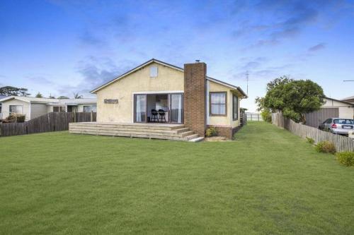 a house with a lawn in front of it at Seaspray home in Tarraville