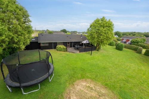 an aerial view of a backyard with a trampoline at Well-Equipped Summer House Near Skovmose in Neder Lysabild