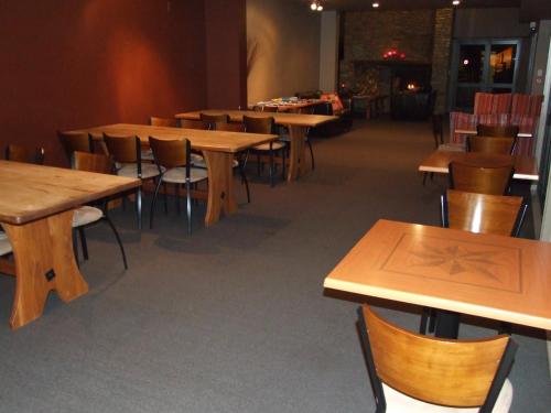 a row of tables and chairs in a room at Drifters Inn in Hanmer Springs