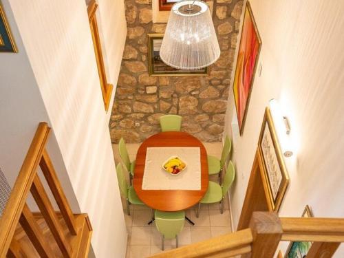a dining room with a table and a stone wall at Villa Mia -Three-Bedroom Villa with Swimming Pool in Trsteno