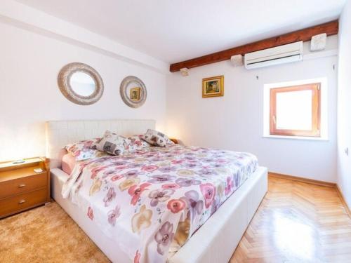 a bedroom with a bed with a blanket with animals on it at Villa Mia -Three-Bedroom Villa with Swimming Pool in Trsteno