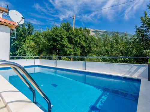 a swimming pool with a view of the mountains at Villa Dalmatian Gem - Two-Bedroom Villa with Terrace and Swimming Pool in Gruda