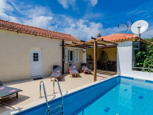 a villa with a swimming pool and a house at Villa Dalmatian Gem - Two-Bedroom Villa with Terrace and Swimming Pool in Gruda