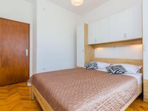 a bedroom with a bed with two zebra pillows on it at Villa Dalmatian Gem - Two-Bedroom Villa with Terrace and Swimming Pool in Gruda