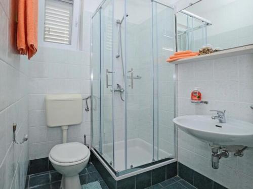 a bathroom with a shower and a toilet and a sink at Holiday Home Odiseja- One Bedroom Apartment with Terrace and Sea View in Brsečine
