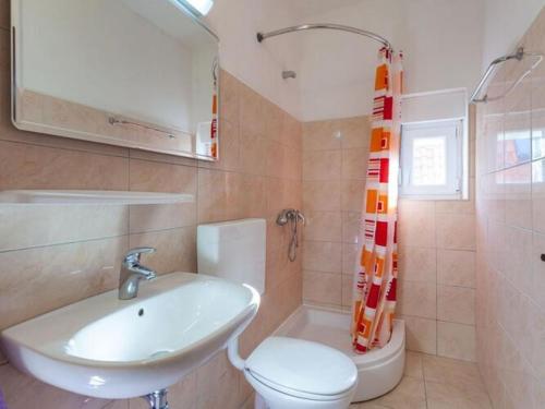 a bathroom with a sink and a toilet at Apartments Nena ST - One Bedroom Apartment with Balcony and Sea View A1 in Pisak