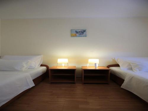 two beds in a room with two lamps on them at Apartment Barbara - Two Bedroom apartment with Terrace in Vir