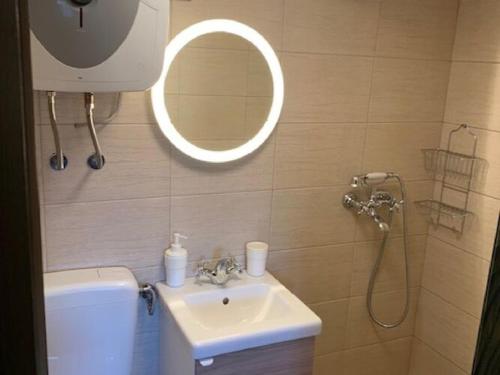 a bathroom with a sink and a shower with a mirror at Holiday Home Anka in Gospić