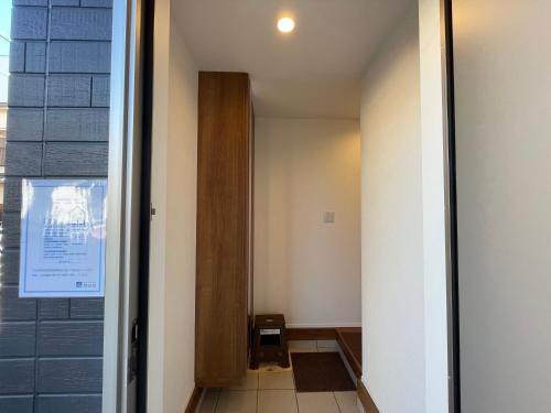 a hallway with a door leading into a room at Starry Ocean in Tokyo