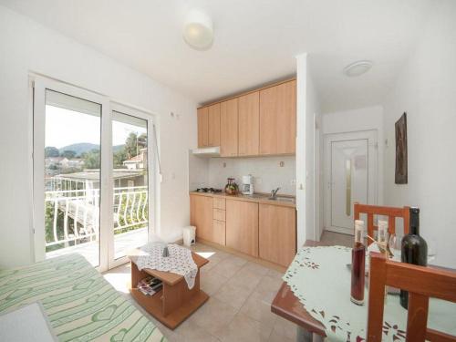 a kitchen with a large window and a table at Bertie's Lodge - One Bedroom Apartment with Terrace and Sea View A2 in Smokvica