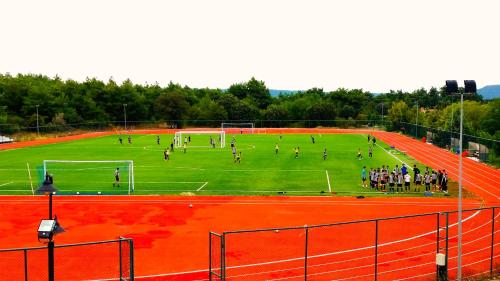 a group of people playing soccer on a field at Dardanos Yerleşkesi in Hamidiye