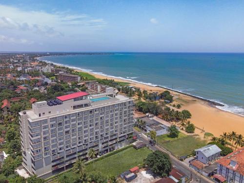 an aerial view of a hotel and the beach at Corundum Breeze Negombo in Negombo
