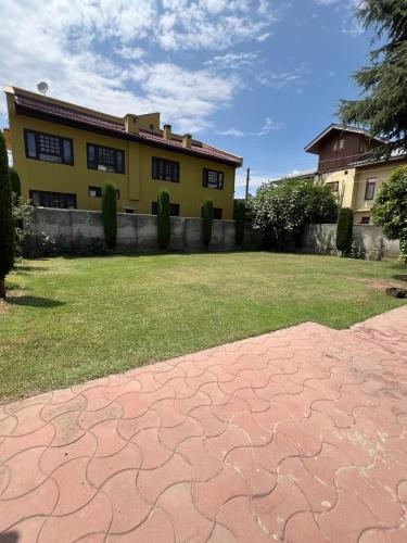 a house with a stone path in front of a yard at Bluebird Retreat in Srinagar