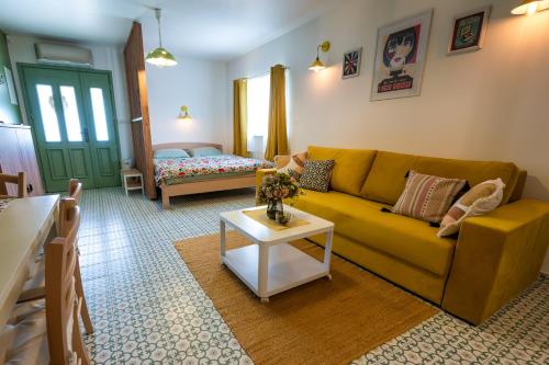 a living room with a yellow couch and a table at Charmdeen in Jastrebarsko