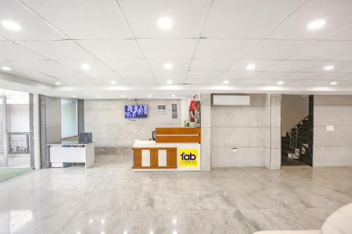 an empty office with a desk in a large room at FabHotel Aerosky - Nr Yashobhoomi Convention Centre in New Delhi