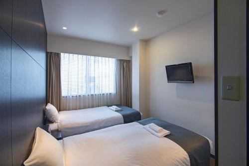 Postel nebo postele na pokoji v ubytování WONZ HOTEL 島之内道顿堀心斎橋難波エリア中心地 New Open Sale