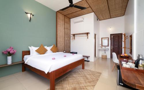 a bedroom with a large bed in a room at The Jungle in Siem Reap