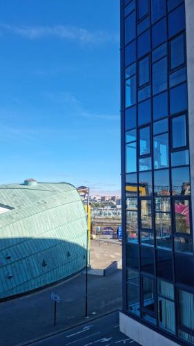 a glass building with a view of a city at St James's the gate in Newcastle upon Tyne