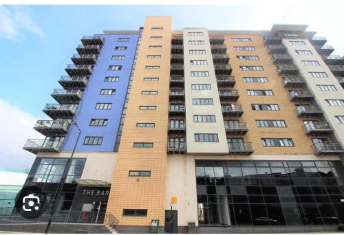 a tall apartment building with the number eight on it at St James's the gate in Newcastle upon Tyne