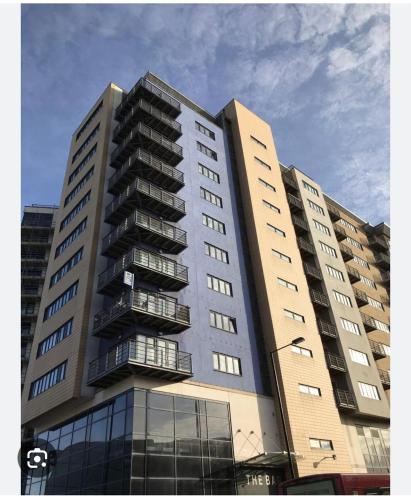 a tall apartment building with a lot of windows at St James's the gate in Newcastle upon Tyne