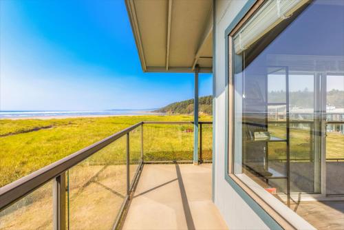a balcony with a view of the ocean at Hi-Tide Resort in Moclips