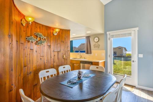 a kitchen and dining room with a table and chairs at Hi-Tide Resort in Moclips