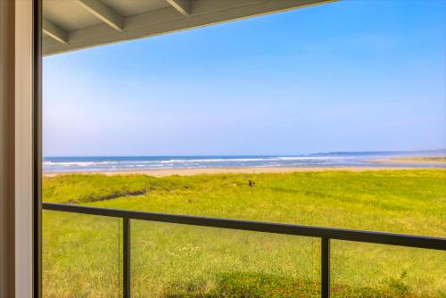 a view of the beach from a house window at Hi-Tide Resort in Moclips