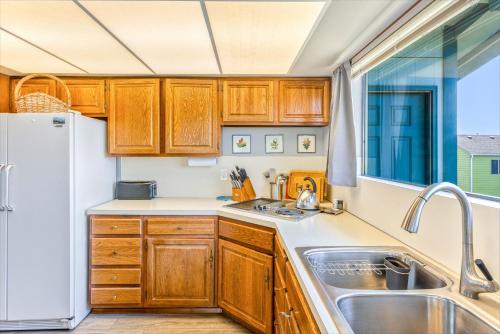 a kitchen with wooden cabinets and a sink at Hi-Tide Resort in Moclips