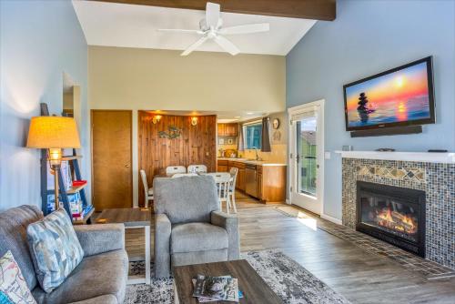 a living room with a fireplace and a tv at Hi-Tide Resort in Moclips