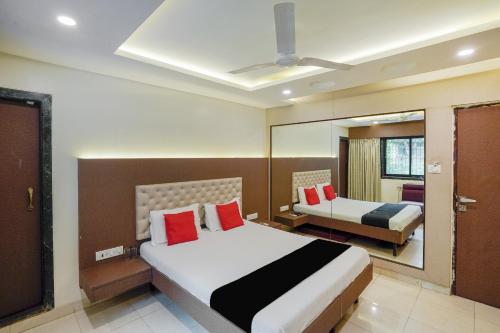 a hotel room with a bed and a mirror at Collection O Sapna in Mire