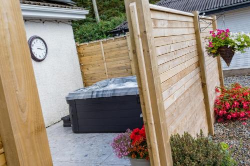a backyard with a fence and a large mattress at Hunters Glebe Country Apartment in Castlerock