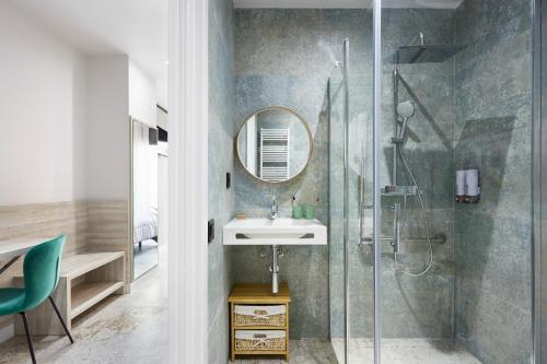 a bathroom with a shower and a sink and a mirror at Urban Sabadell 2 in Sabadell