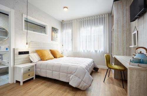 a bedroom with a bed and a desk and a sink at Urban Sabadell 2 in Sabadell