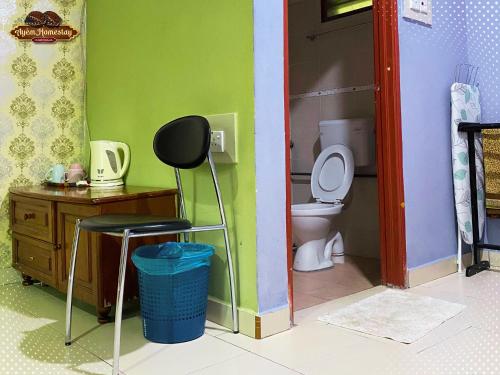 a toy bathroom with a toilet and a chair at Ayem Homestay UTHM in Parit Raja