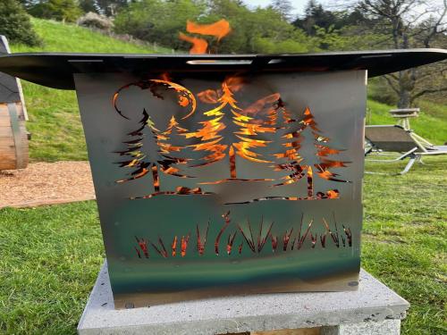 a fire pit with a painting of a forest at Ferienhaus Wendelinus mit Pool & Sauna in Hausach