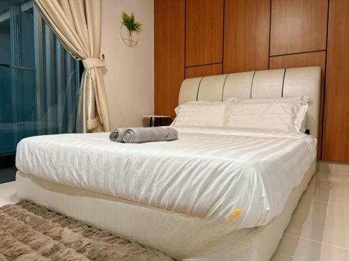 a large white bed in a room with a window at The Shore Cozy Suite in CBD in Kota Kinabalu