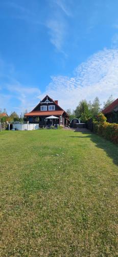 a large yard with a house in the background at ŻurawZdory 107 in Zdory