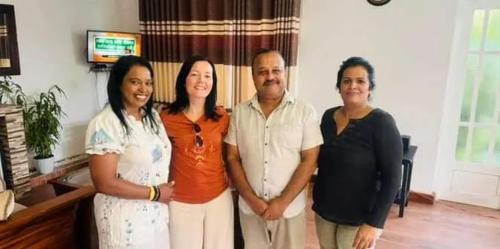 a group of people posing for a picture in a living room at Kandy Home stay in Katugastota