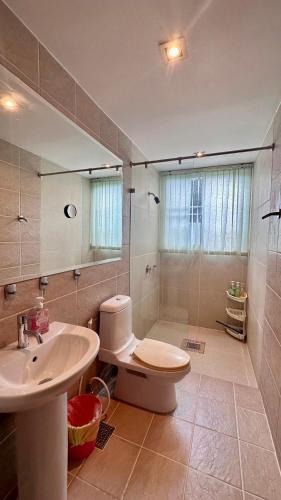 a bathroom with a sink and a toilet and a shower at Seaview Condominium A12 in Ban Tha Fat